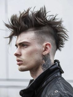 The Burst Fade Mohawk with Disconnected Undercut offers a stark contrast between the voluminous top and shaved sides, making it ideal for those looking to make a strong impression in casual or eclectic settings. This style suits straight or wavy hair types and complements square or round face shapes by elongating the appearance. Undercut One Side, Mohawk Reference, Queer Mohawk, Mohawk Bangs, Mowhak Hairstyle, Spiked Mohawk, Masc Hairstyles, Comic Hair, Modern Mohawk