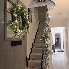 the stairs are decorated with garlands and wreaths