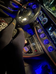 the interior of a car is lit up with blue lights