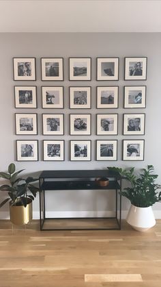 there are many framed pictures on the wall in this living room, and one is black and white