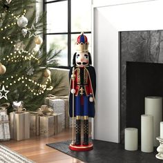 a christmas tree with presents in front of it and a nutcracker statue next to it