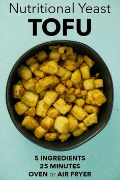 a bowl filled with fried tofu on top of a blue table