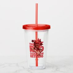 a red and clear cup with a straw in it sitting on a marble countertop