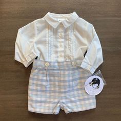 This Is A Brand New Sarah Louise Button On Short Set. The Shirt Is White With Blue Stitching Down The Front, On The Collar And At The Cuffs. The Blue And Khaki Checked Shorts Are Fully Lined And Button On To The Bottom Of The Shirt. The Shorts Are Gathered In The Back. Please Take The Time To Look Closely At The Pictures To See All The Work That Goes Into These. All Of My Items Are New From My Closed Children's Store. I Am Listing At Fair Prices So Please Do Not Send Silly Offers. Cute Fitted Sets With Buttons, White Long Sleeve Sets With Button Closure, Blue Buttoned Set For Spring, Blue Buttoned Sets For Spring, Spring Blue Set With Buttons, White Button-up Sets For Spring, Spring Playtime Sets With Button Closure, Mini Mouse Outfit, Minnie Mouse Sweatshirt