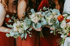 the bridesmaids are holding their bouquets together