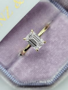 This astonishing ring has a luxurious 1.25 carat lab grown emerald cut center diamond and is IGI certified at "E" in color and "VVS2" in clarity, (Excellent Cut, Polish and Symmetry) and is set in a classy minimalistic solitaire setting in 14K yellow gold. The ring can also be made in white/rose gold or platinum and can even be redesigned to your choice. Comes with IGI certification and our lifetime warranty as well. Rose Gold Emerald Cut Ring, Emerald Engagement Ring 1 Carat, Emerald Cut Yellow Gold Engagement Ring, 1 5 Carat Emerald Engagement Ring, 2 Carat Emerald Cut Engagement Ring, Yellow Gold Emerald Cut Engagement Ring, Solitaire Emerald Cut Engagement Ring, Emerald Cut Engagement Ring Set, Gold Emerald Cut Engagement Ring