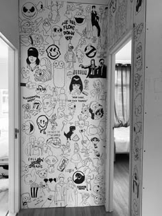 an open door leading to a bedroom with cartoon drawings on the wall and flooring