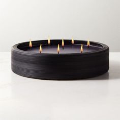 a black candle holder with five candles in it