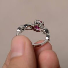 This is a gorgeous handmade creation. Its beauty is its simplicity & Elegance. The 7*7 mm round shape faceted lab Ruby is crafted in solid sterling silver and with rhodium plated. Main stone weight about 1.66 ct. cz as accents. All item is sent in a beautiful gift box If you have any idea of design your ring,pls contact me directly. You can realize more lovely stuff clicking the link https://www.etsy.com/shop/knightjewelry?refshopsection_shophome_leftnav Please leave the correct address and Sterling Silver Round Cut Ruby Wedding Ring, Exquisite Silver Round Ruby Ring, Silver Birthstone Ring With Round-cut Lab-created Ruby, Luxury Sterling Silver Ruby Ring With Round Cut, Ruby Cocktail, Silver Ruby Ring With Hallmark, Round Cut, Rings Red, Cut Rings, Ruby Rings