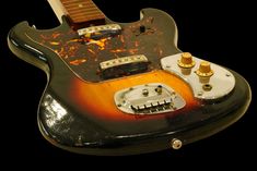 an electric guitar is shown with rust on the body and pick - up knobs