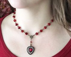 "Big scarlet red and romantic heart pendant necklace with lots and lots of sparkle! Adjustable antiqued brass chain with a lobster claw clasp allows a longer 18\" length necklace or go for a shorter choker style necklace when the mood suits you. Super versatile and will fit into your wardrobe easily. I've used sparkly red faceted glass beads for that extra shine. The pretty heart setting drops perfectly for a lovely focal point to this necklace. Your beautiful necklace will be carefully packaged Big Statement Necklace, Red Statement Necklace, Vintage Heart Necklace For Valentine's Day Party, Vintage Red Necklace With Heart Charm, Vintage Red Heart-shaped Necklace, Vintage Red Jewelry With Heart Beads, Red Heart Beads Necklace For Wedding, Vintage Heart Necklace With Lobster Clasp For Valentine's Day, Vintage Red Heart Necklace