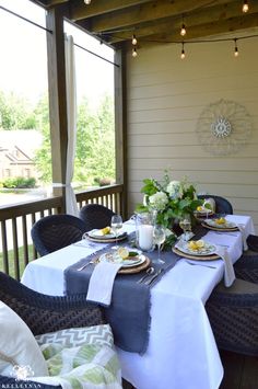 the table is set for two on the porch