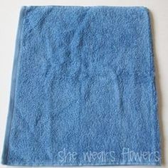 a blue towel with the words she wears flowers written on it