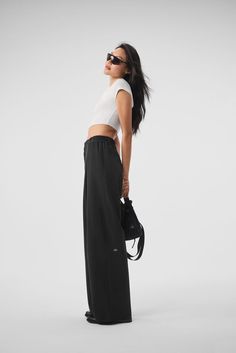 These trousers have “closet staple” written all over them. They have a high-rise waistband (flat in the front and stretchy in the back), classic details (belt loops and pleats) and a relaxed, wide-leg fit. Plus, they’re made from a lightweight, slightly stretchy fabric that looks sleek and feels totally comfortable. You'll go straight from work to your weekend plans with just a change of shoes. Woman Back, Back Women, Black Xs, Alo Yoga, Modern Fit, Stretchy Fabric, High Rise, Trousers, High Waisted