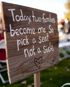 a wooden sign that says today two families become one so pick a seat not a side