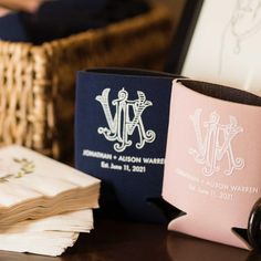 two personalized mugs sitting on top of a table next to some folded papers