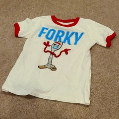 Toy Story 4 Forky Character T Shirt With Red Collar And Sleeve Cuffs. No Tags, But Shirt Was Never Worn. Red Character Print T-shirt For Playtime, Fun Red T-shirt For Playtime, Red Letter Print Top For Playtime, Red Letter Print Tops For Playtime, White Fun T-shirt For Playtime, Fun White T-shirt For Playtime, White Fun Style T-shirt For Playtime, White Cotton Tops For Play, Top Toddler Toys