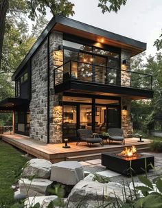 a modern house built in the woods with stone walls and flooring, an outdoor fire pit