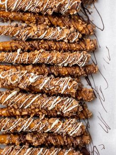 an assortment of cookies with white icing and chocolate drizzled on top