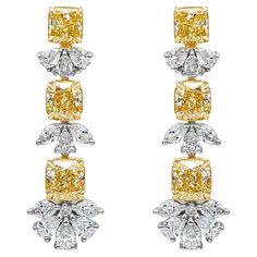 An elegant pair of drop earrings, showcasing six vibrant radiant cut fancy yellow diamonds weighing 6.43 carats total with VS clarity, set on a four prong 18K yellow gold setting. Accented by clusters of mixed-cut diamonds weighing 2.70 carats total with F color and VS clarity, set on platinum. Omega clasps are made with 18K yellow gold. Style available with matching pendant.  Roman Malakov is a custom house, specializing in creating anything you can imagine. If you would like to receive a special quote on a custom piece, please message or call us. Colored Diamond Jewelry, Diamond Chandelier Earrings, Diamond Chandelier, Gold Basket, Diamond Solitaire Earrings, Fancy Jewellery Designs, Yellow Diamonds, High Jewellery, Fancy Yellow Diamond