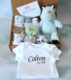 a baby gift box with a teddy bear and other items