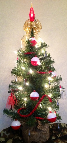 a small christmas tree decorated with red, white and gold ornaments