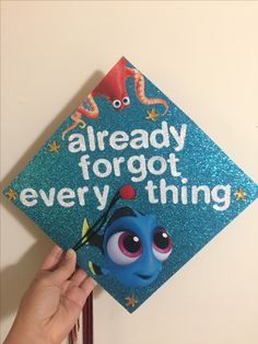 someone is holding up a blue graduation cap that says, already forgot everything on it