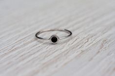 Gorgeous, simple, filigree ring with black gemstone- black onyx handcrafted in 14k white gold. The onyx is a natural gemstone, Earth mined. In the back of the ring secret heart. Makes it perfect gift to celebrate Valentine's day, anniversary, birthday or any other occasion. This ring is made to order in YOUR SIZE. CENTER STONE: *100% natural, AAA quality onyx *round cabochon *color: black *diameter: 3mm APPROXIMATE MEASUREMENTS OF THE RING: *onyx with setting: 4.5mm *band: approximately 1mm *mat Elegant Stackable Black Rings, Dainty Black Ring For Gift, Dainty Black Ring As Gift, Minimalist Onyx Gemstone Ring, Black Dainty Ring As Gift, Black Sterling Silver Stackable Jewelry, Stackable Black Sterling Silver Jewelry, Modern Black Jewelry With Bezel Setting, Minimalist Black Enamel Jewelry For Anniversary