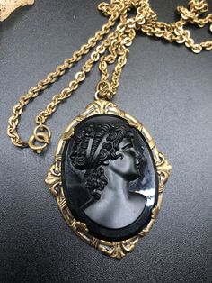 antique art deco black molded glass cameo lady gold filled chain pendant necklace beautiful piece Victorian revival. This is a really beautiful solid piece I was told that it was Victorian but I'm guessing that it is a little bit later on in the 1900s I am not the most familiar with these but this is really a beautiful piece and well-made. The chain is approximately 24 inches. Vintage Black Medallion Necklace, Vintage Black Cameo Jewelry, Vintage Black Cameo Necklace, Black Cameo Necklace In Vintage Style, Black Cameo Medallion Necklace, Victorian Revival, Glass Molds, Cool Necklaces, Antique Art Deco