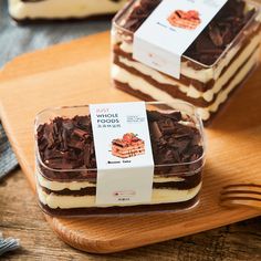 three desserts on a wooden tray with forks