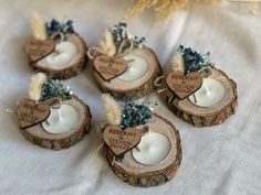 four wooden slices with candles in them on a table