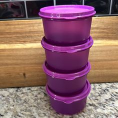 purple plastic containers stacked on top of each other