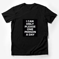 Make a statement with this bold and humorous graphic t-shirt! Perfect for those days when you want to remind everyone that you can only please one person a day. This tee is made with high-quality material for comfort and durability. The black background highlights the white text that playfully says, I CAN ONLY PLEASE ONE PERSON A DAY. It's a unisex fit, ideal for anyone looking to add a touch of sarcasm to their wardrobe or searching for a fun gift for a friend with a sense of humor. Easy to wea Funny Black Slogan Top, Funny Black Tops With Slogan, Funny Quote Print Black Tops, Funny Slogan Shirt For Streetwear, Funny Black T-shirt With Graphic Print, Graphic Tee T-shirt With Quote For Streetwear, Graphic Tee With Quote Print For Streetwear, Graphic Tee With Quote Print And Crew Neck, Black Crew Neck T-shirt With Funny Text