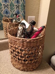 a wicker basket filled with personal items on top of a bathroom counter next to a sink