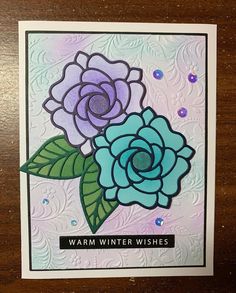 a close up of a card on a table with a flower and words that read warm winter wishes