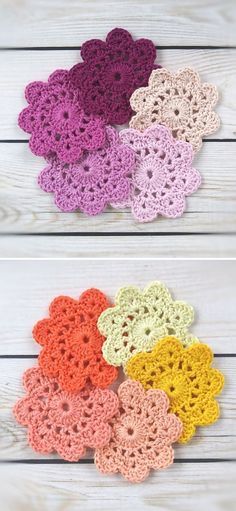 crocheted flowers are arranged in different colors on a white wooden surface, one is pink, the other is yellow