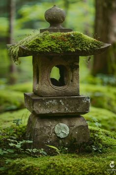 a stone lantern with moss growing on it