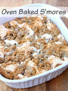 an oven baked s'mores casserole in a white dish on a wooden table