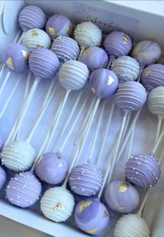 purple and white cake pops in a box