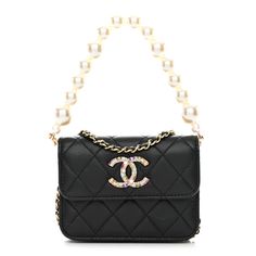 This is an authentic CHANEL Lambskin Quilted Zirconium Pearl Card Holder Flap With Chain in Black. This stylish bag is crafted of luxuriously soft diamond quilted lambskin leather in black. The bag features a leather threaded chain strap, a removable pearl strap, and a facing flap with a gold Chanel CC logo with multicolored crystals. The flap opens to a black fabric interior. Chanel Canvas, Chanel Clutch, Chanel Crossbody, Quilted Wallet, Gold Chanel, Chanel Shoulder Bag, Leather Thread, Diamond Quilt, Cc Logo