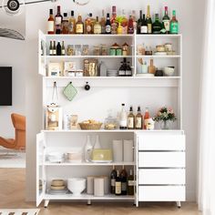 a white shelf filled with lots of bottles