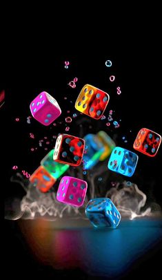 colorful dices are flying in the air with bubbles coming out of them on a black background