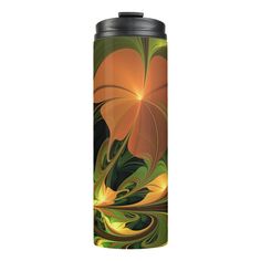 an orange and green floral design on a black metal flask cup with lid,