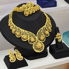 Indulge in luxury with this exquisite Necklace Set, perfect for wedding parties. With its opulent design and superior craftsmanship, this set features a necklace, bracelet, earrings, and ring. Make a lasting impression and elevate your style with this luxurious jewelry set." Exquisite Gold Bridal Necklace For Formal Events, Exquisite Gold Bridal Necklace For Formal Occasions, Exquisite Gold Bridal Necklace For Formal, Exquisite Gold Jewelry Sets With Elegant Design, Elegant Plated Bridal Sets For Wedding, Elegant Yellow Gold Bridal Sets For Party, Exquisite Gold Jewelry With Intricate Design, Exquisite Gold-plated Jewelry With Elegant Design, Elegant Bridal Sets With Intricate Design For Party