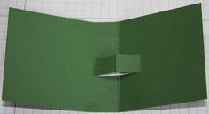 an origami box is folded in green paper