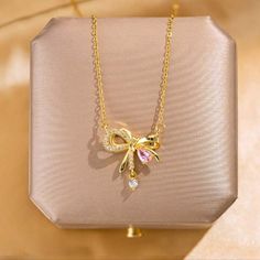 New Beautiful!! Stainless Steel Gold Tone Bow Know Pendant With Cz's Necklace. Necklace Has An Extension On The Clasp. Perfect For Yourself Or As A Gift. Very Unique And Different. Very Shiny And Brilliant!! Suitable For All Occasions. Suitable For Most Ages. Nwt Bow Necklace Gold, Pink Rhinestone Clavicle Chain Necklace, Pink Clavicle Chain Rhinestone Necklace, Elegant Pink Rhinestone Necklace For Party, Elegant Pink Rhinestone Party Necklace, Elegant Pink Rhinestone Necklace For Gift, Pink Cubic Zirconia Clavicle Necklace, Elegant Pink Rhinestone Necklace Gift, Pink Cubic Zirconia Rhinestone Necklace As Gift