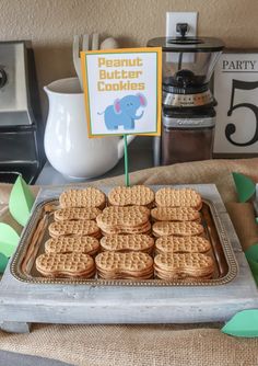 there are waffles and cookies on the table with a sign that says peanut butter cookies