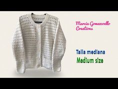 a white crocheted sweater with the text,