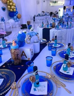 a table set up with blue and gold decorations