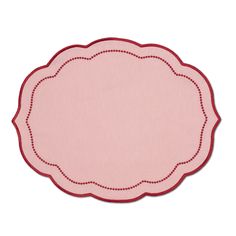 a pink place mat with red trimmings on the edges and a scalloped edge